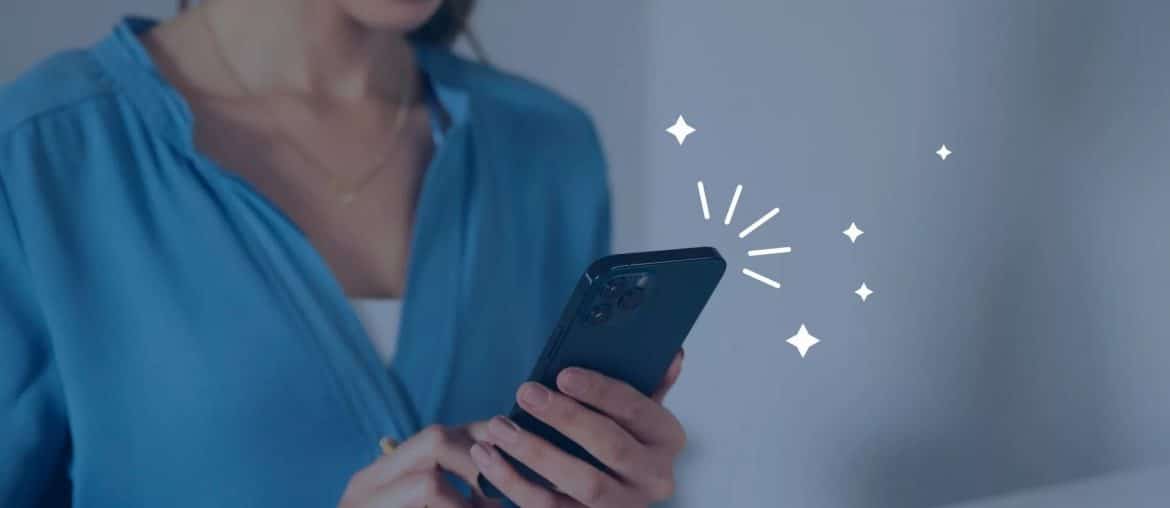 Woman smiling at phone with sparkles
