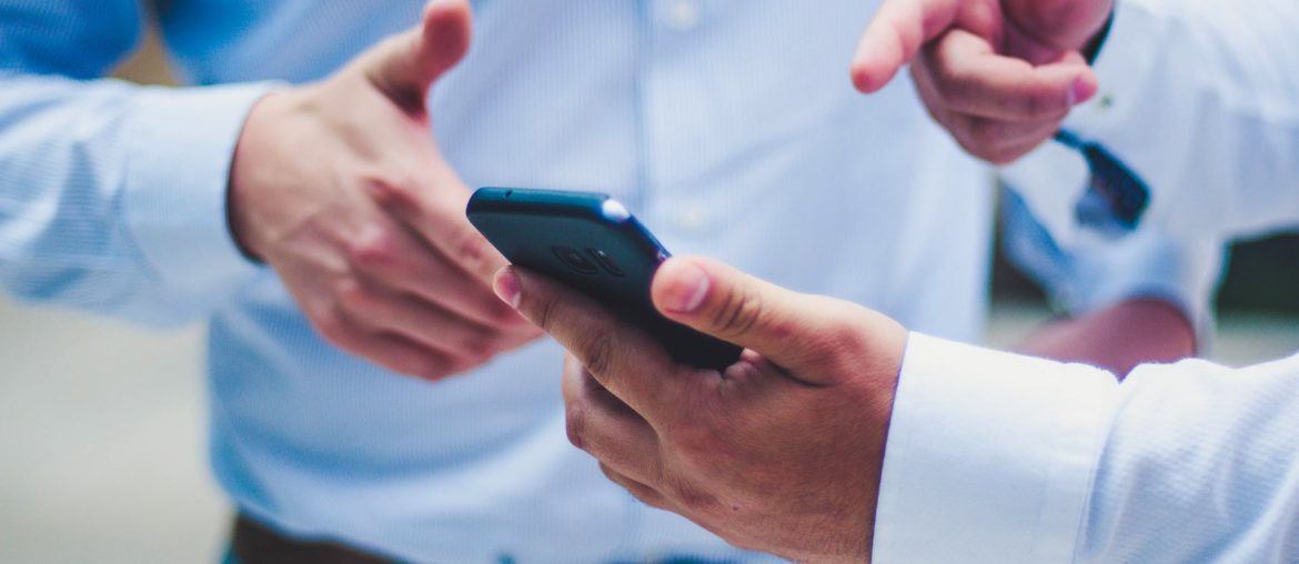 Two people discussing something on a smartphone