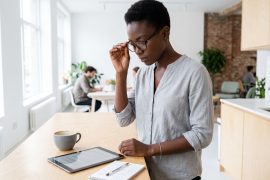 Woman consulting a tablet in a bright office