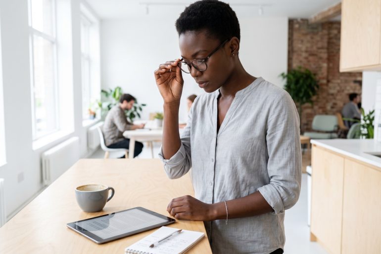 Woman consulting a tablet in a bright office